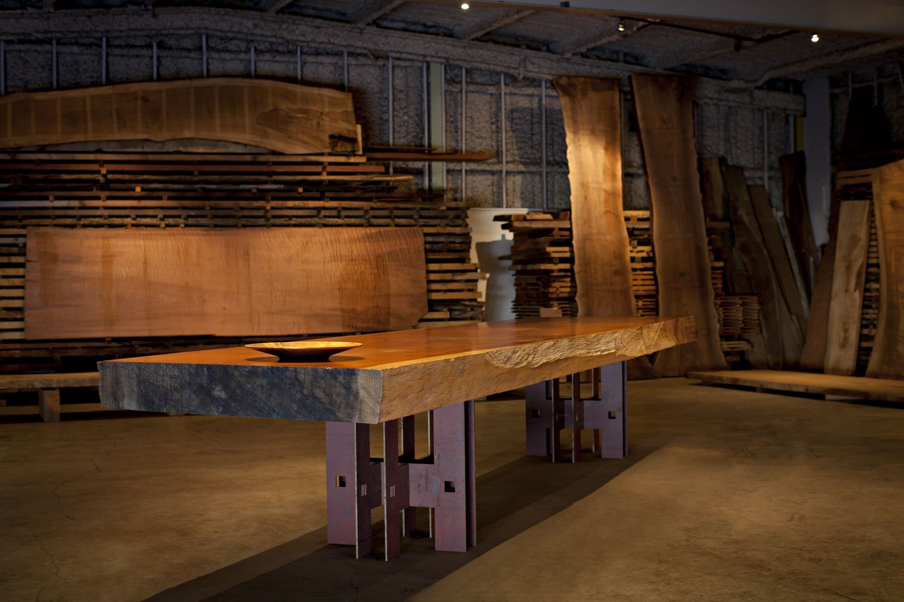 A reclaimed redwood slab table in the Original Timber warehouse